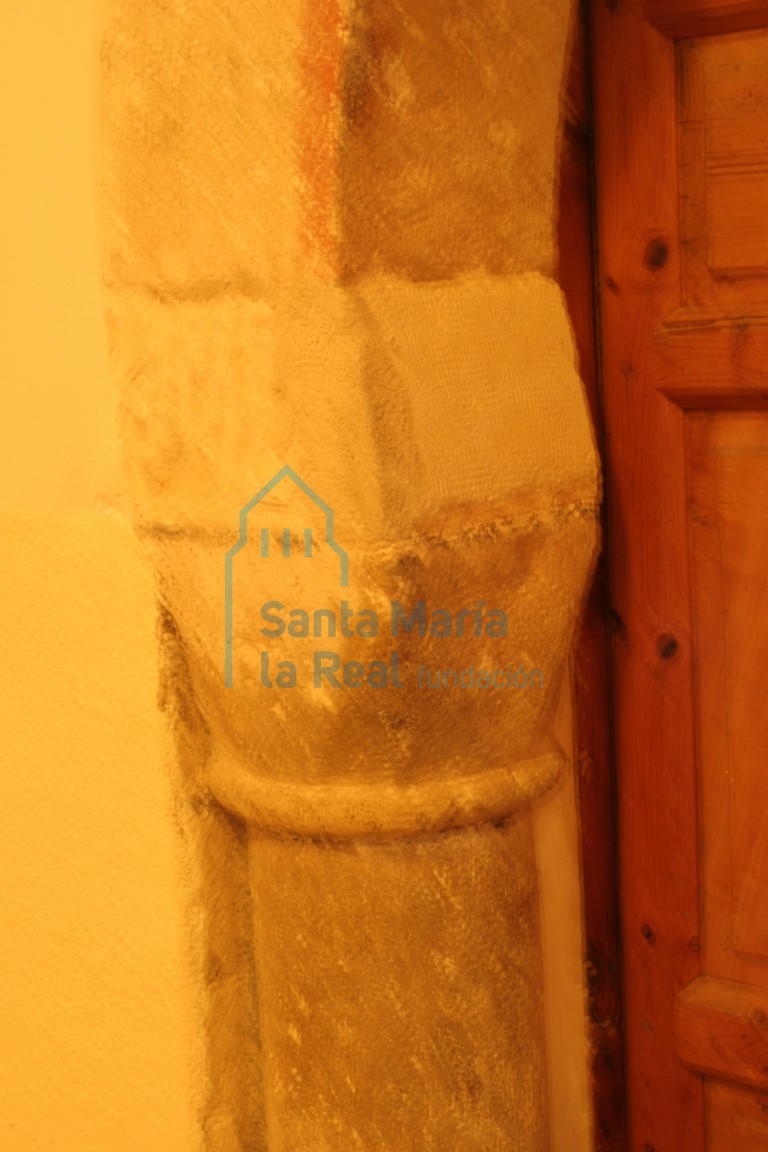 Capitel liso sin decoración de la portada románcica reubicada