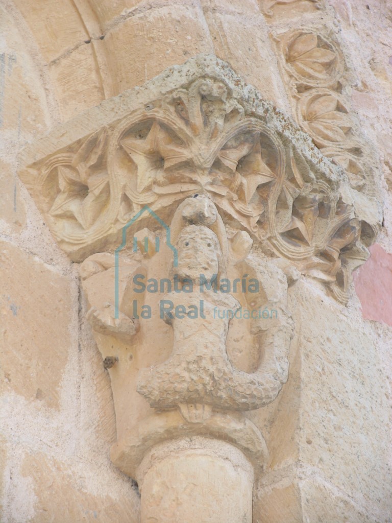 Capitel de una sirena de doble cola en la ventana del ábside