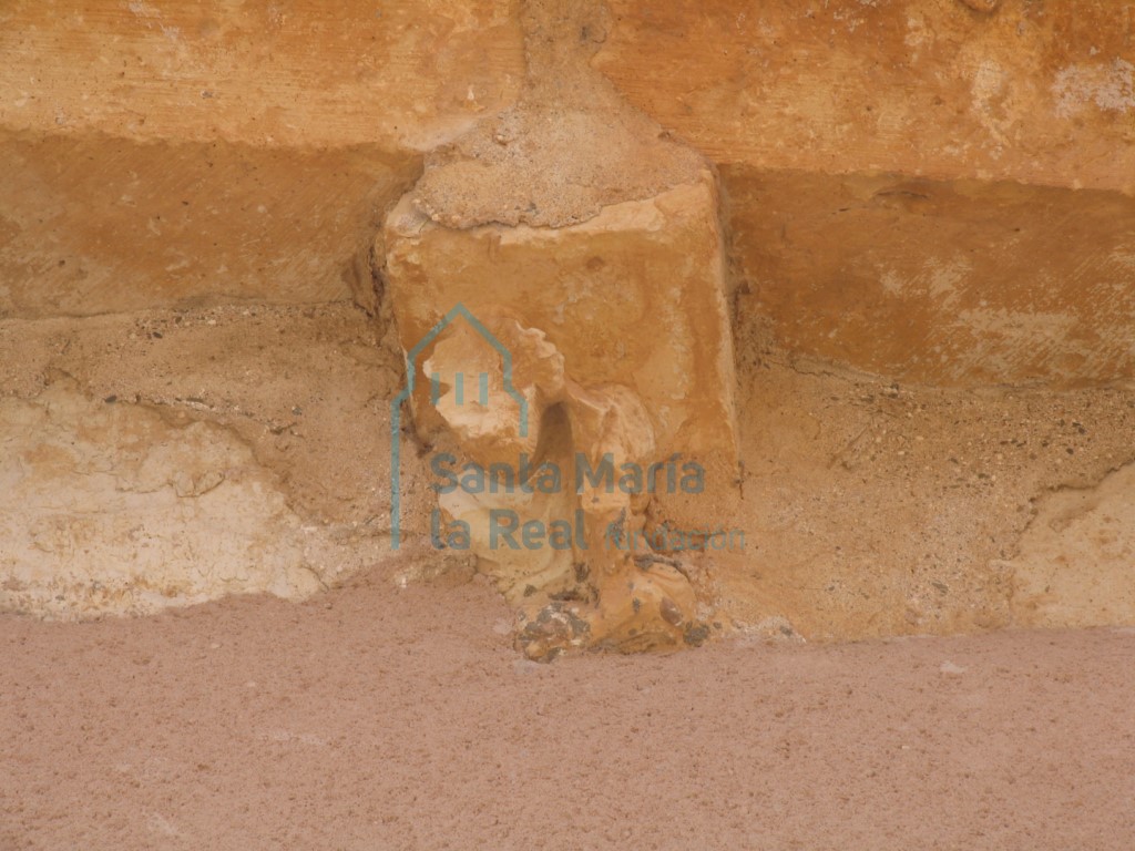 Canecillo con figura humana en la cornisa del muro septentrional